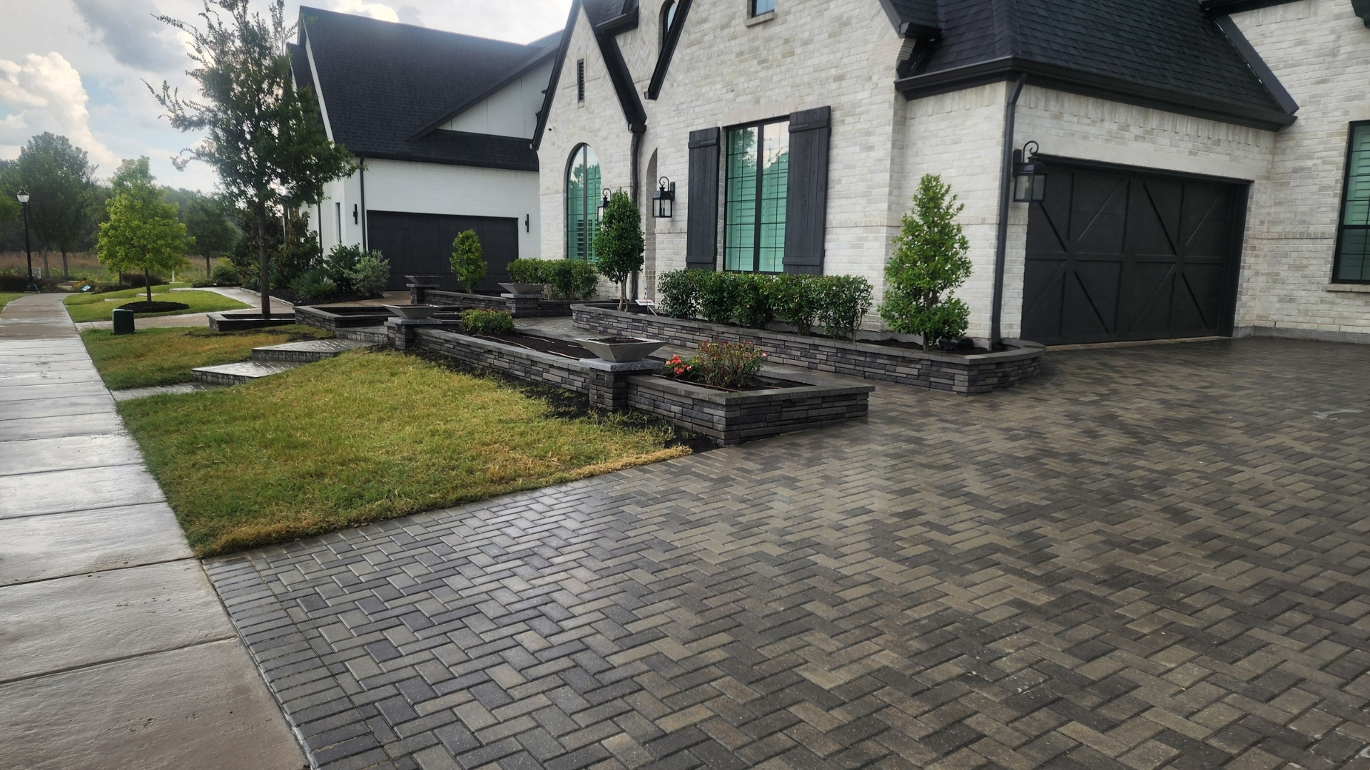 modern-black-paver-driveway-dark-stone-planters-frisco-prosper-tx